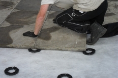 Installing slabs onto paving pads