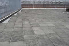 Paved podium deck on plastic pads