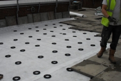 Plastic pave pads supporting paving slabs