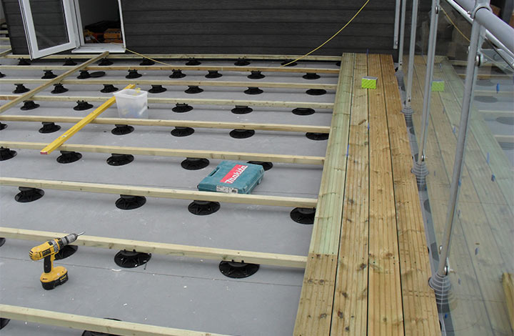 Decking being installed on pedestals at oakwood group