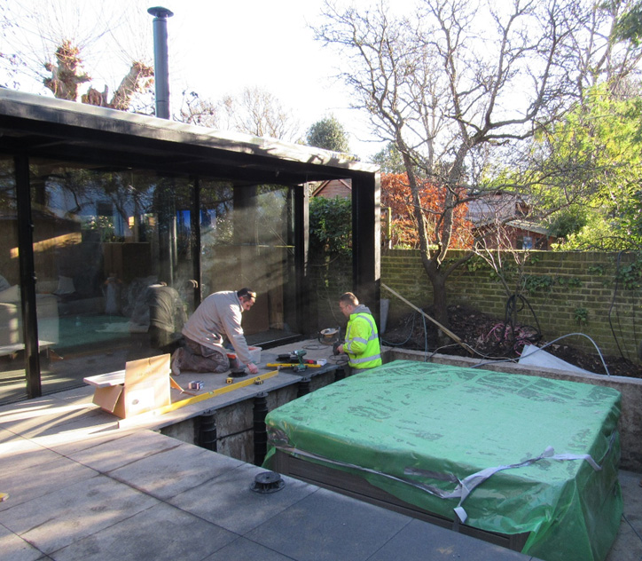 An image of adjustable support pedestals being installed at Grove Park, Chiswick