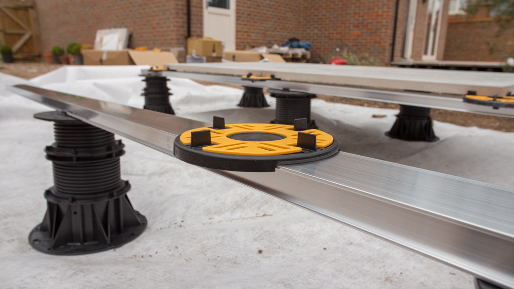 laying aluminium rail joist bearer onto adjustable pedestals