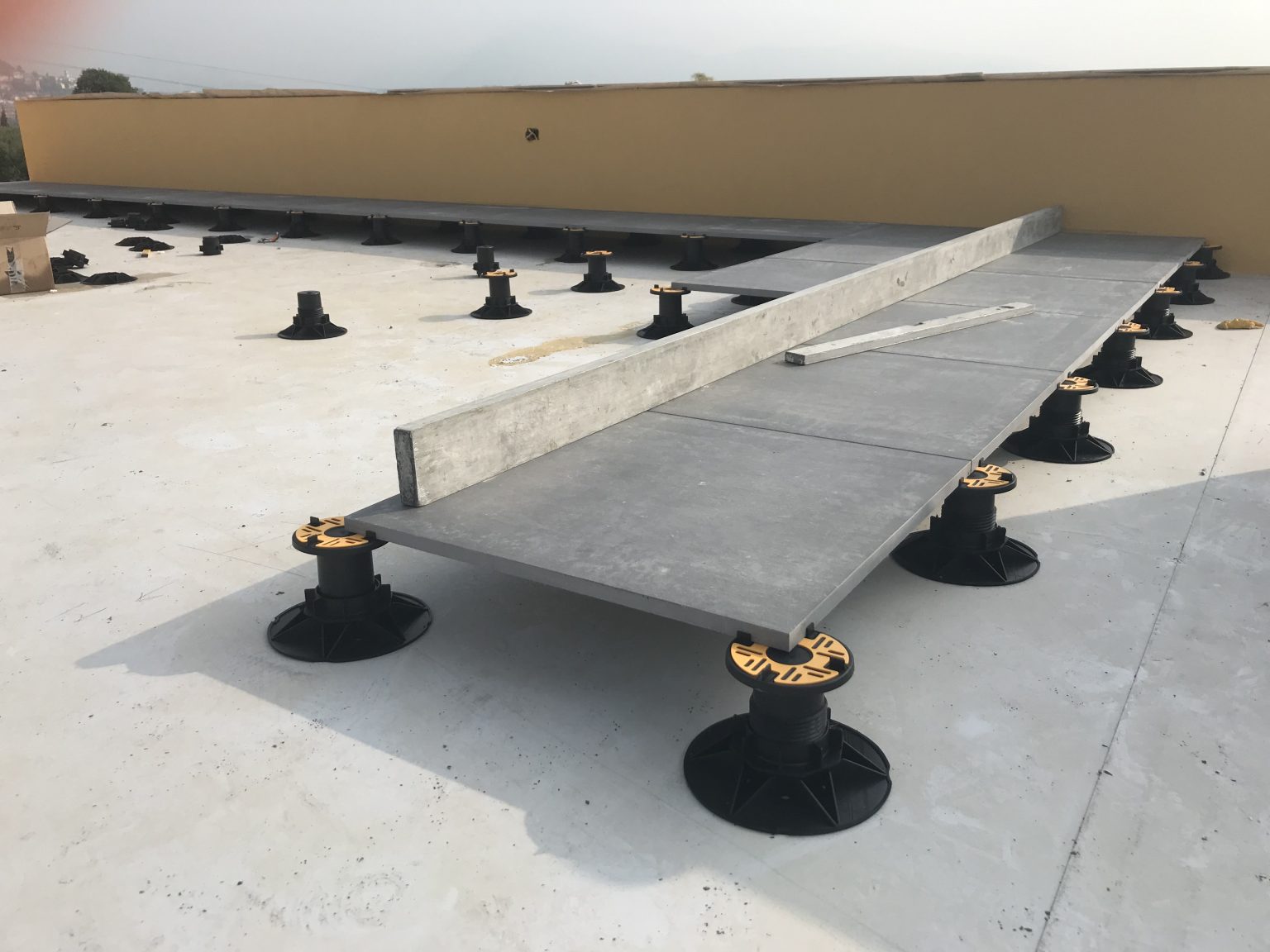 Universal adjustable pedestal with porcelain tiles on large terrace