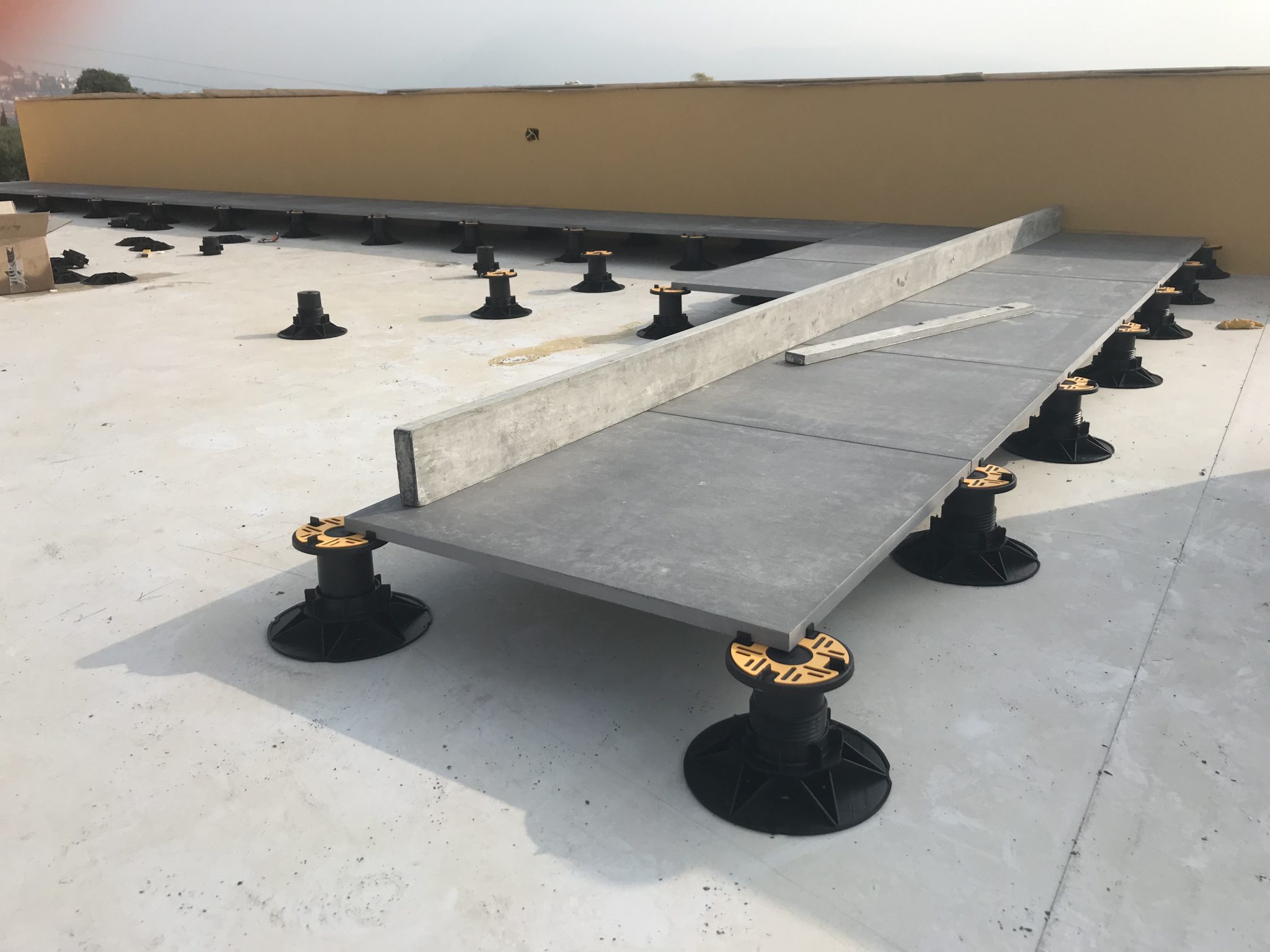 Universal adjustable pedestal with porcelain tiles on large terrace