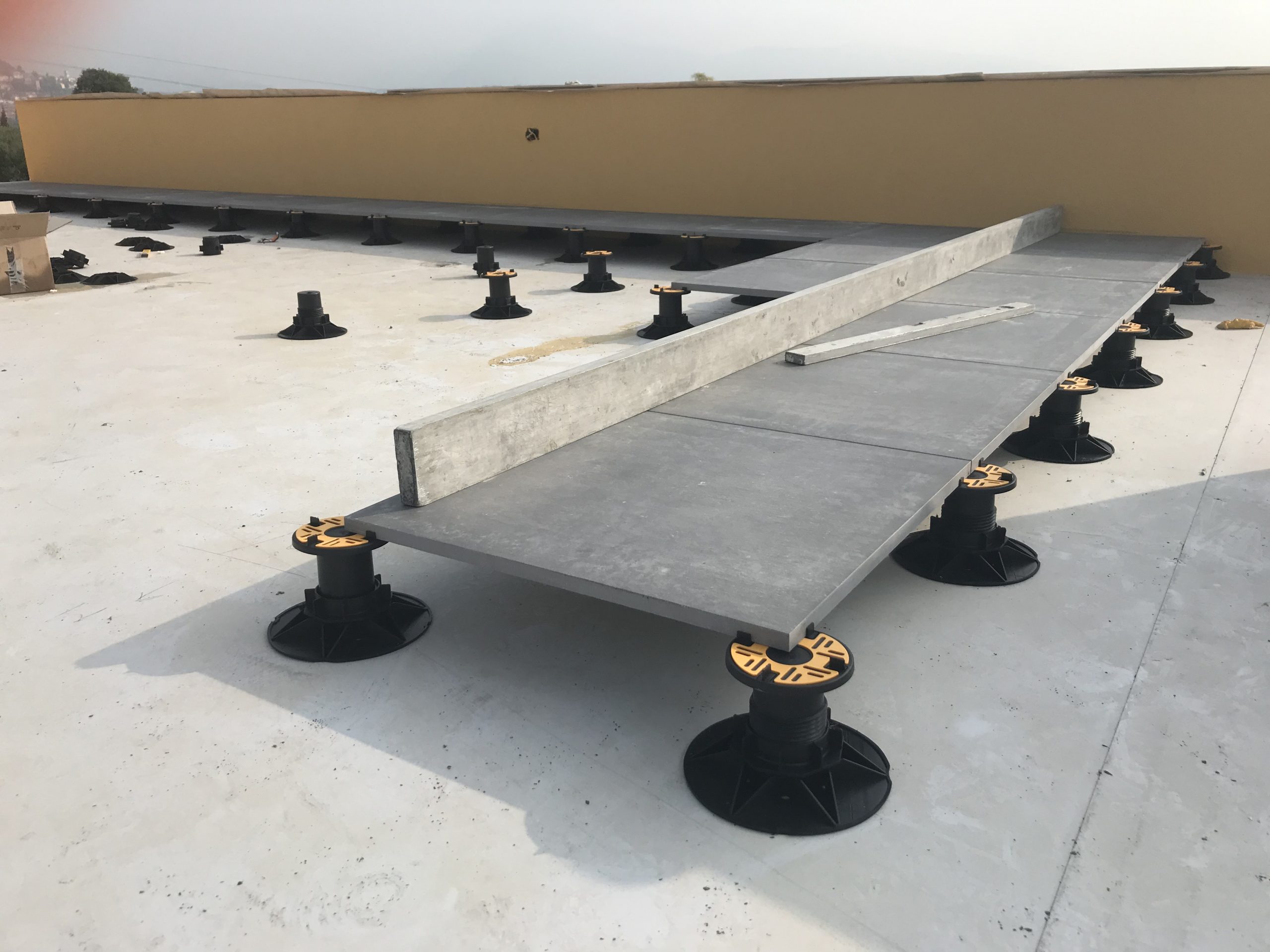 Universal adjustable pedestal with porcelain tiles on large terrace